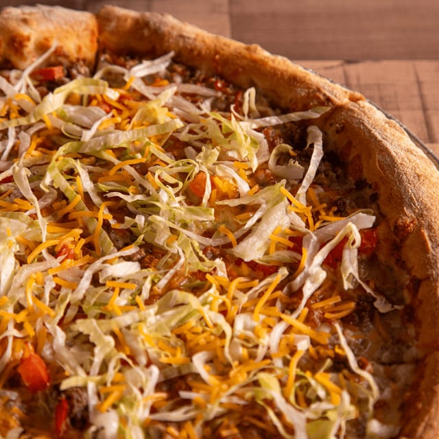 Taco pizza slice.